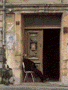 woman sitting in door.GIF (81538 bytes)